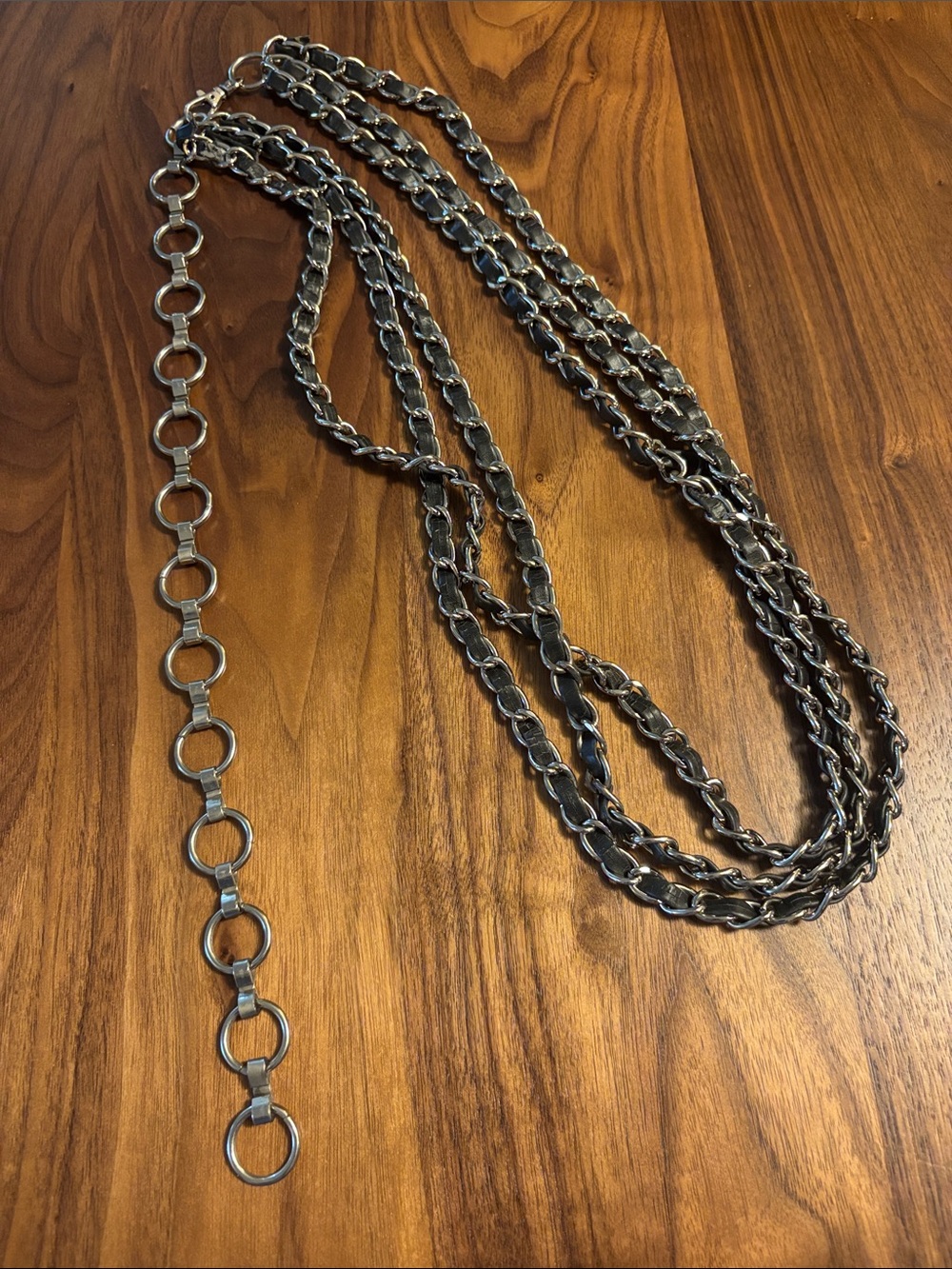 Multi strand silver and black leather chain belt.